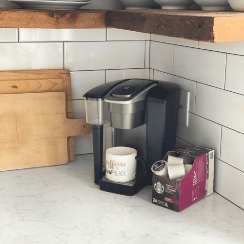 keurig coffee maker on white kitchen counter with kcups