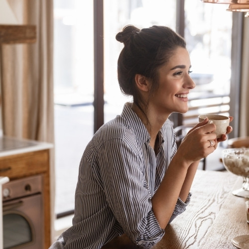 woman drinking espresso at home